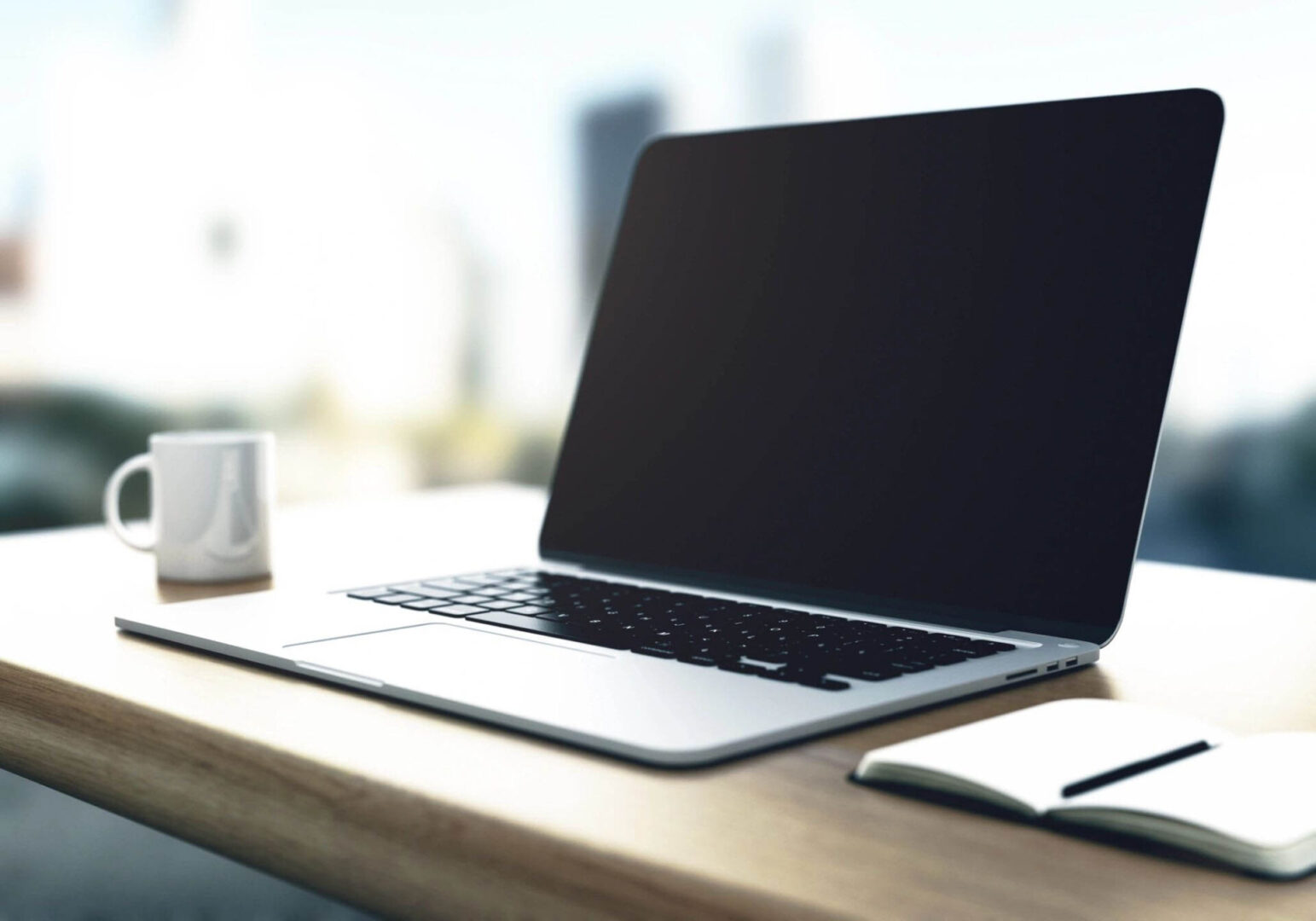 Macbook Sitting on Table with Coffee in the Background