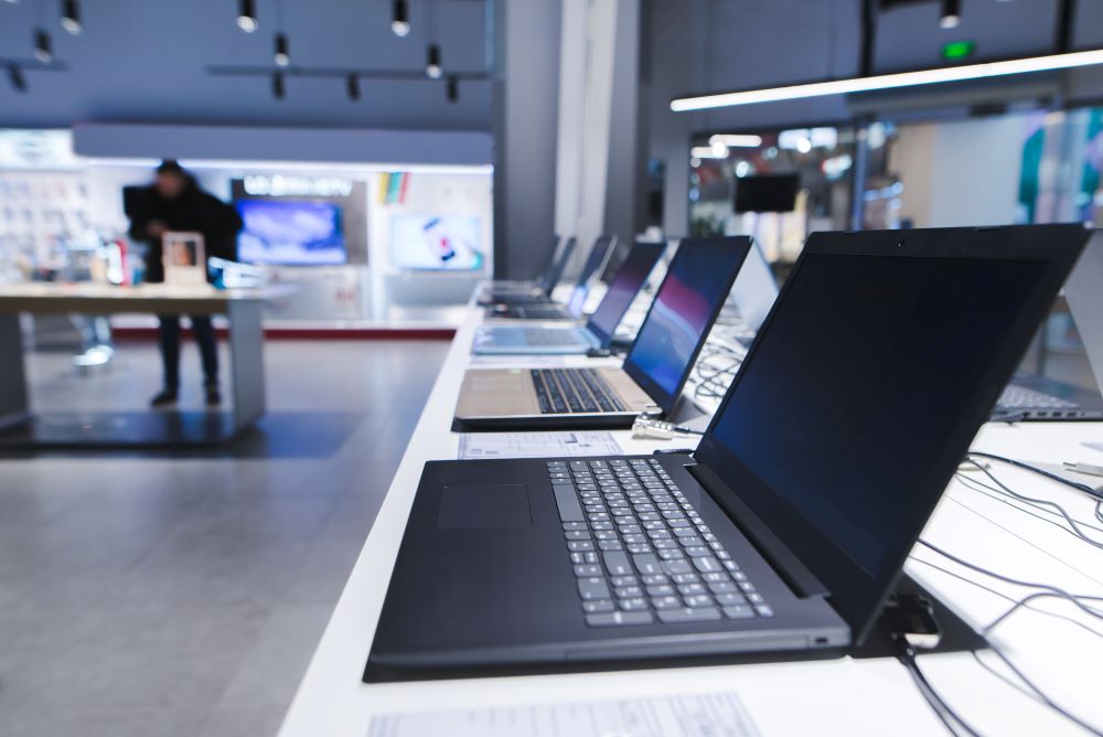 Row of premium laptops available at a computer store.