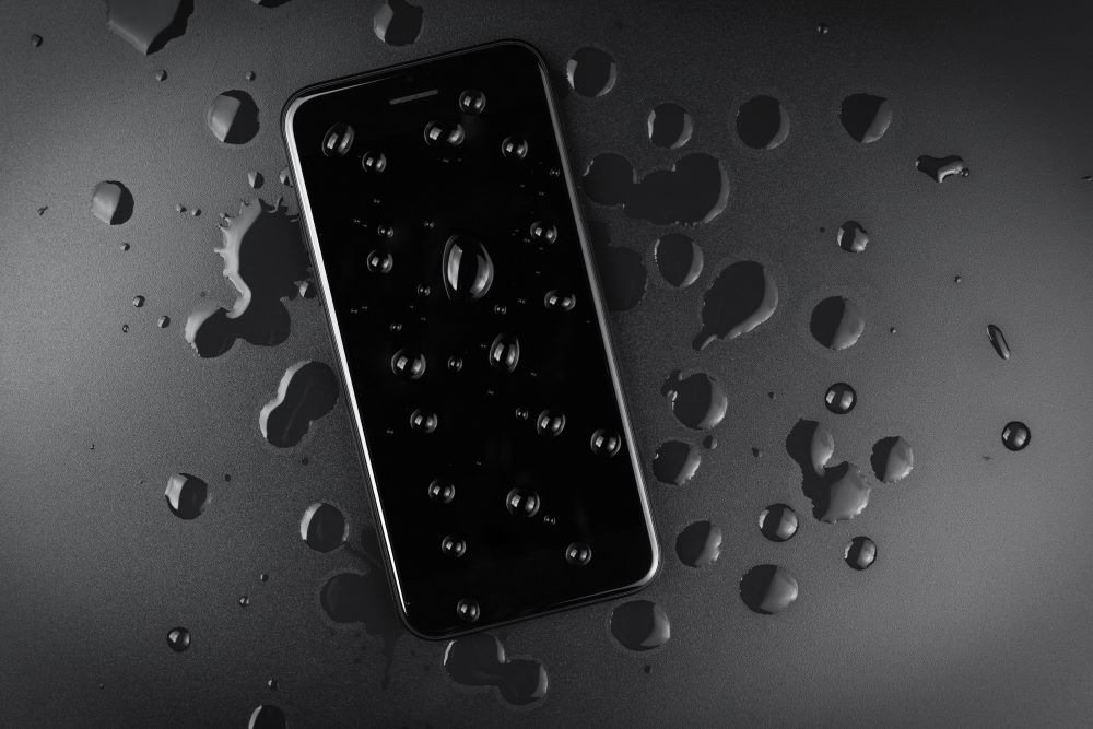 An iPhone with water droplets on the screen.