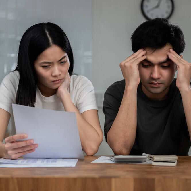 Stressed couple looking at the bills