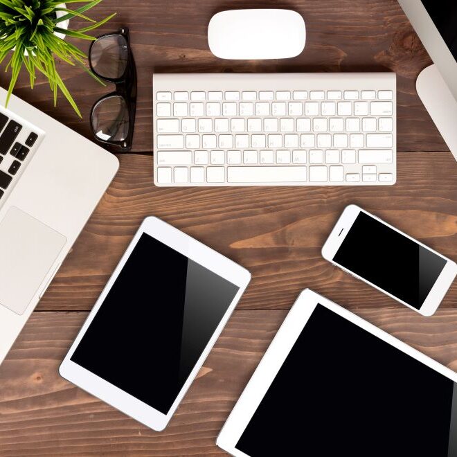 A desk full of Apple products on display.