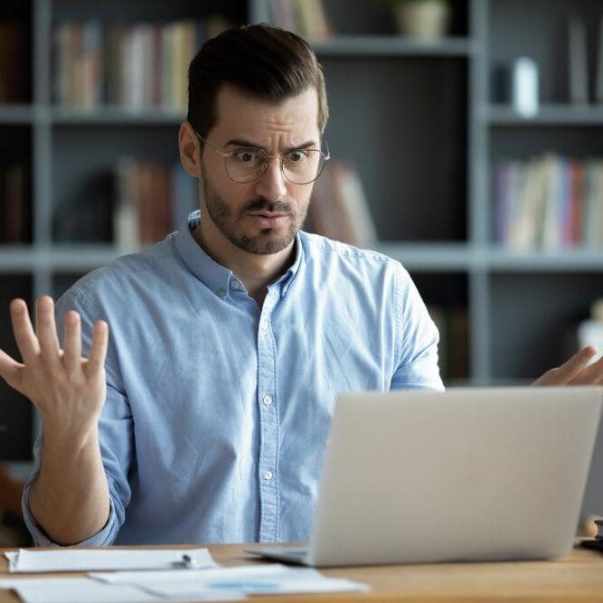 EmergencyComputerRepairCaliComp A man with a confused expression after his computer crashes unexpectedly.