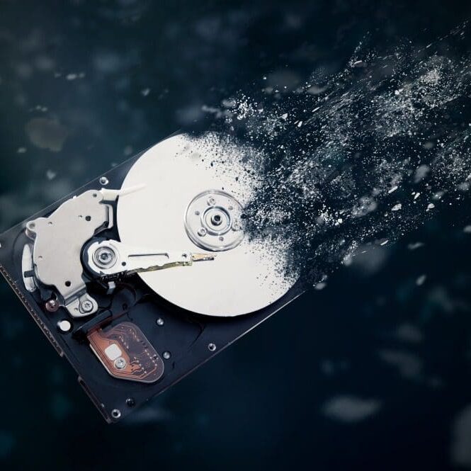 HardDriveDestructionStandardsCC An old hard drive being destroyed.
