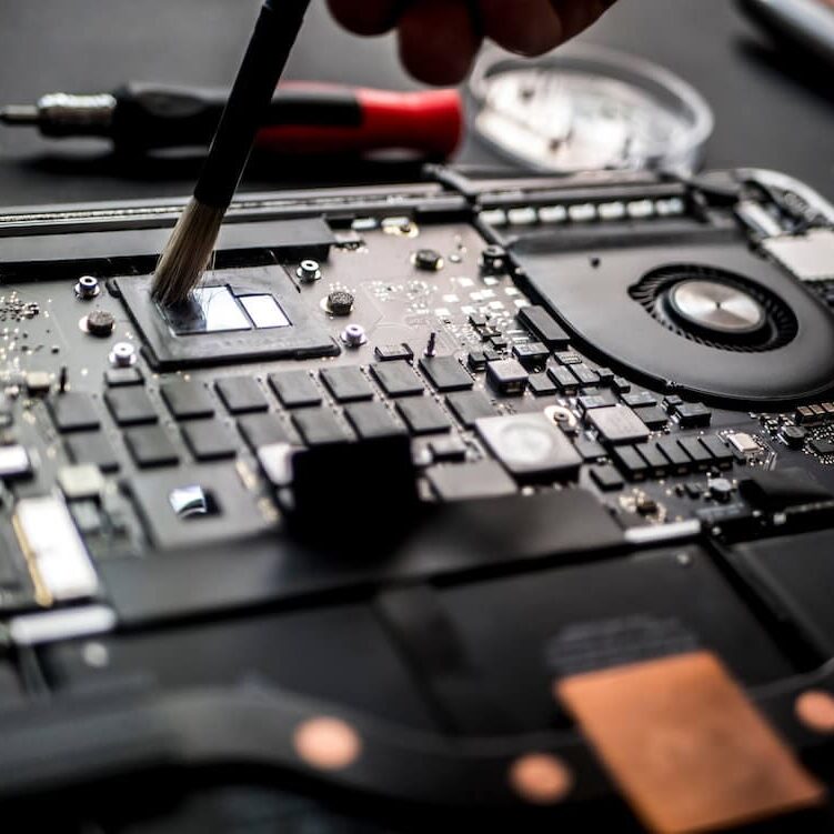 How to Properly Prep Your Device for a Laptop Trade-In: Your Trusted Partner, California Computer prepping a laptop keyboard for a laptop trade in