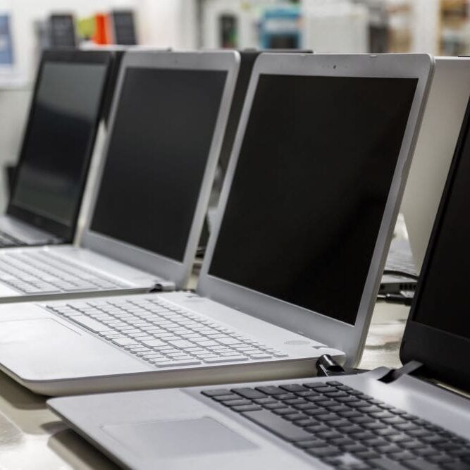 LaptopUpgradeCaliforniaComputer A row of used laptops getting prepped for a laptop trade in.