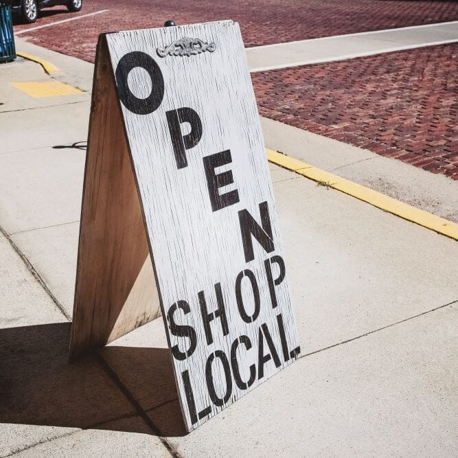 LocalComputerRepairCaliComp A "shop local" sign outside of a small local business.